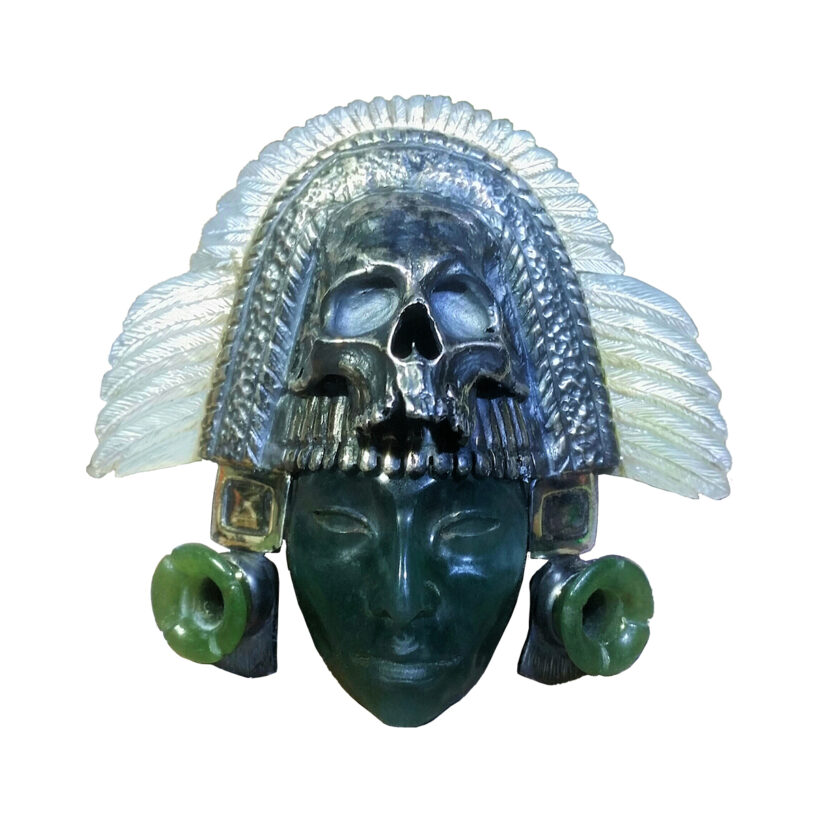 THE LORD OF XIB´ALB´A Inspired on the Mayan Gods of Infra World. Hand carved in a composition of different materials: White Feathers carved in Mother of Pearl and represent Purity. The Silver and Skull represent Death. The Plug Earrings carved in gem quality Green Jade from Guatemala, this jade color mean Power and Status. The gem quality Blue Jade Mask represent an enlightened being, someone ethereal. The Blue Jadeite was exclusively used for carvings and funerary offerings for the Mayan Royalty and other important personalities with the purpose to preserve life after death. Author: Dante López 3RD PLACE AWARD AT THE INTERNATIONAL ZI GANG BEI JADE EXHIBITION NOVEMBER 15, 2016 . SUZHOU, CHINA. Original Piece. Private Collection, USA. XIB´ALB´A The Mayan Universe can be explained in three levels or cosmic areas ruled by Gods that are not always well defined, different energies manifest on each of these levels: HEAVEN Level was divide on 13 layers. EARTH Level was the middle world, the material or fleshly world. INFRA WORLD Level, XIB´ALB´A, the afterlife, hereafter, formed of 9 layers. Despite the clear division, the three worlds are closely connected and even some times intermingled. We could tell they form a “continuum”, with no real borders since all three are part of the Great Cosmic Tree of Life that raises its crown to Heaven and grows the roots to the deepest of the Infra World. Through this “Tree of Life” it is possible to travel or transit from one region to the other, it is the path that communicate and intertwine everything that exists. The underworld had a sense of depth, not in the meaning of space. The Access to this region of darkness and shadows had place after death or even in life through special rituals. Cycle of Life transited from Earth to Infra World and from Infra World to Heaven. Same path had to be follow by humans who aspired superior conscious levels during human existence: He first had to interiorize down to its own Infra World and auto discover himself though different challenges in life in order to ascend to his own Heaven in Life.